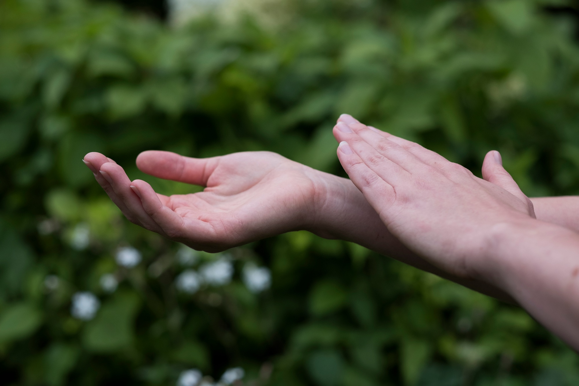 Close up of hands touching, EFT tapping therapy technique.